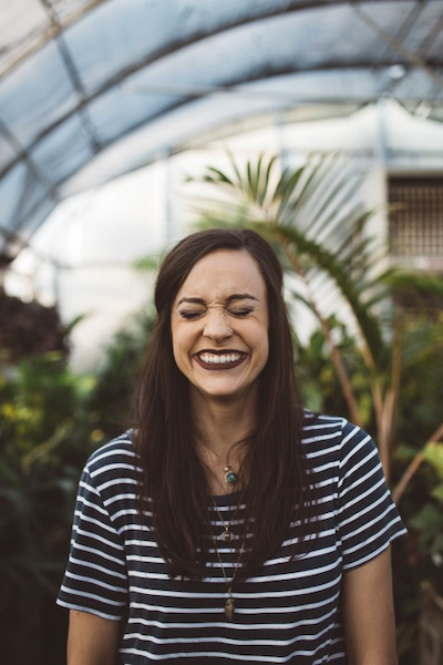 A person using a tool to smooth the edges of their Invisalign aligners